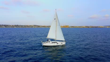 Side-aerial-drone-view-of-a-sail-boat-in-the-Pacific-Ocean-off-the-coast-of-Southern-California