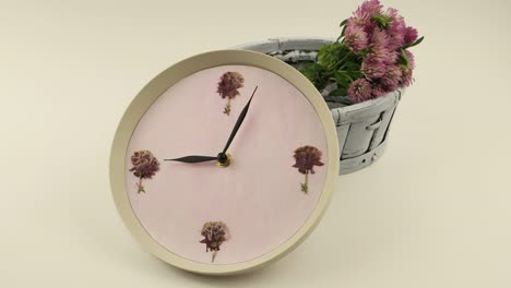 clock and a wicker basket of clover flowers