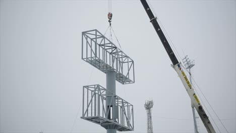 installing a billboard with a crane in winter