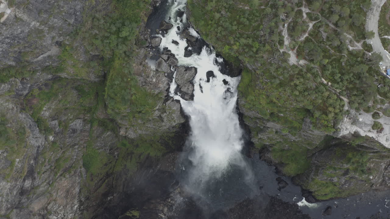 Aerial View of a Majestic Waterfall in a Mountainous Landscape