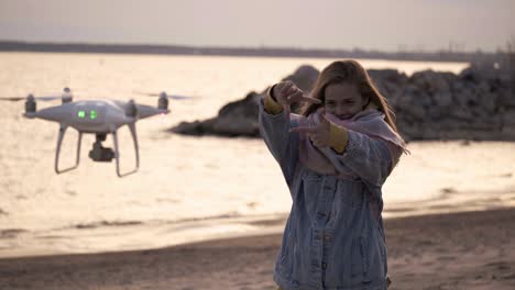 sunset seaside and happy girl take video by drone