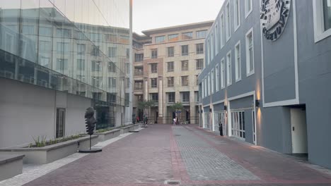 An-alleyway-in-the-late-afternoon-on-a-summer-evening-in-the-Silo-District-of-the-famous-Victoria-and-Alfred-Waterfront-in-Cape-Town,-South-Africa