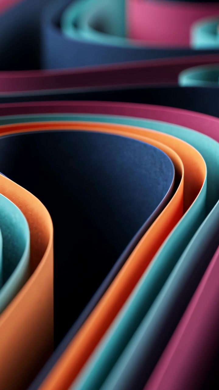 Vertical video: Sliding camera showing curled paper rolls on studio table, revealing color shifts