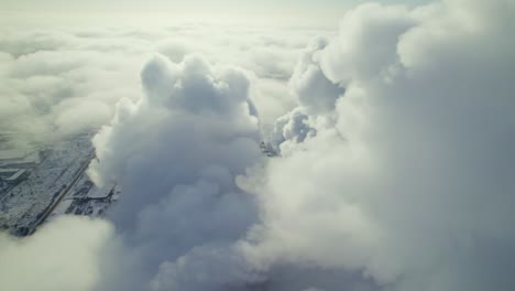 industrial smoke clouds over snowy landscape