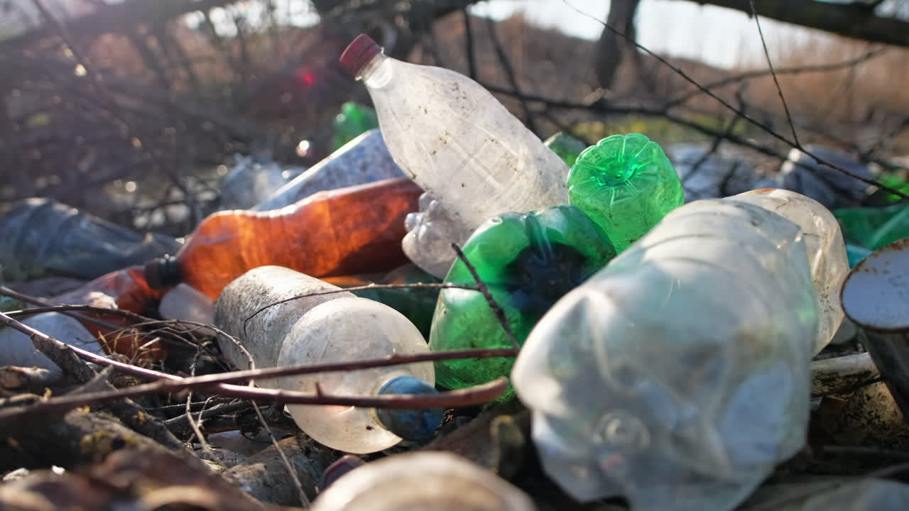 River coast with a lot of scattered plastic bottles