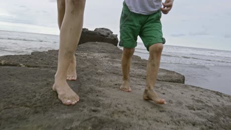 young mother and son walking on sand