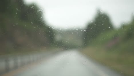 windscreen wiper wiping car glass in a rainy day on the road, slow motion