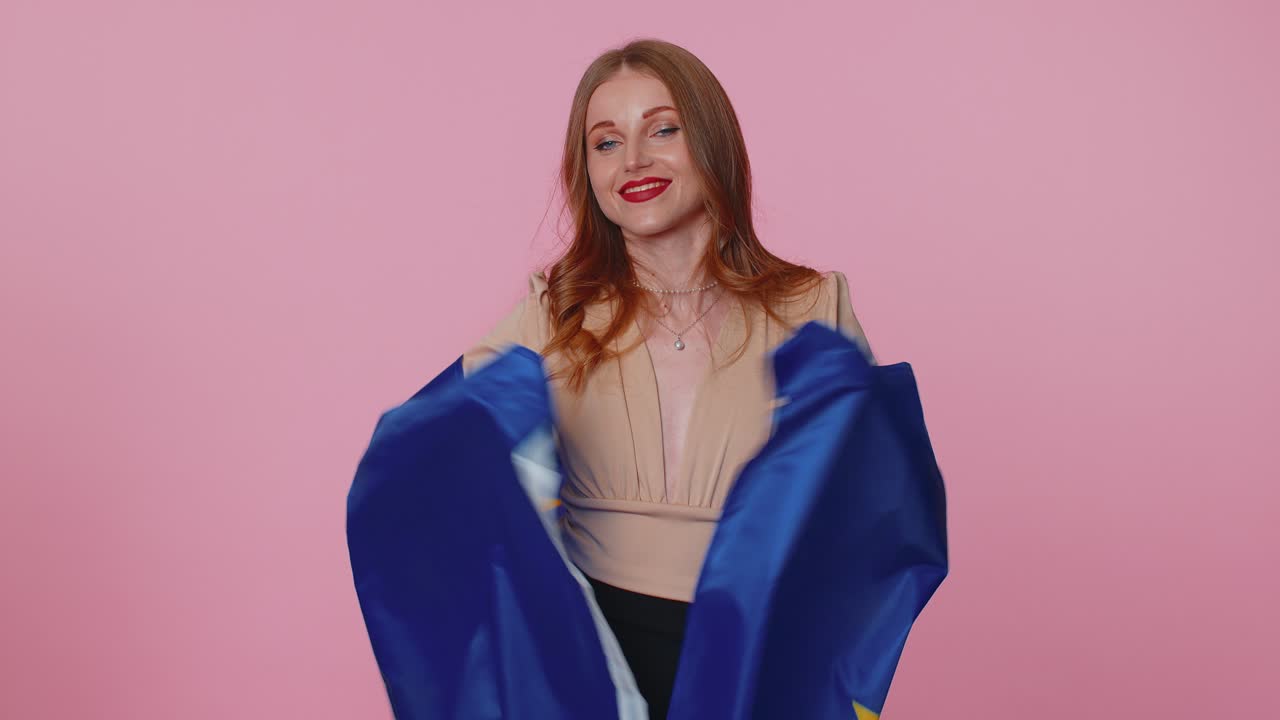 Pretty teen girl waving european union flag smiling cheering democratic laws human rights freedoms