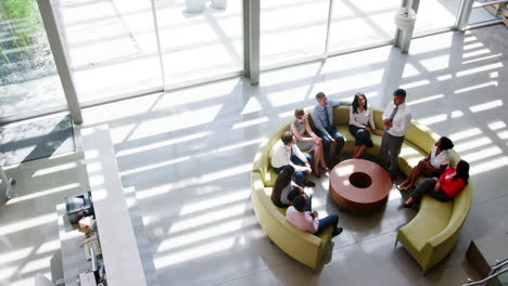 Businessman-presenting-at-a-team-meeting,-elevated-view