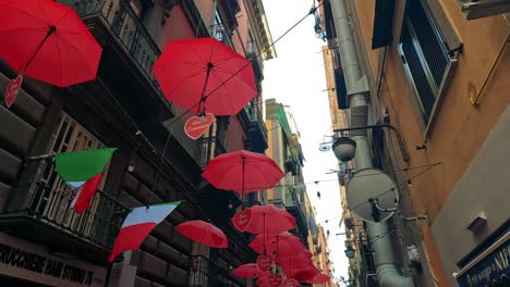 vibrant umbrellas decorate a narrow naples street