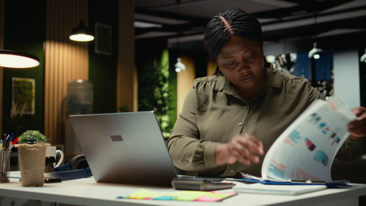 Female employee researching and documenting data reports numbers