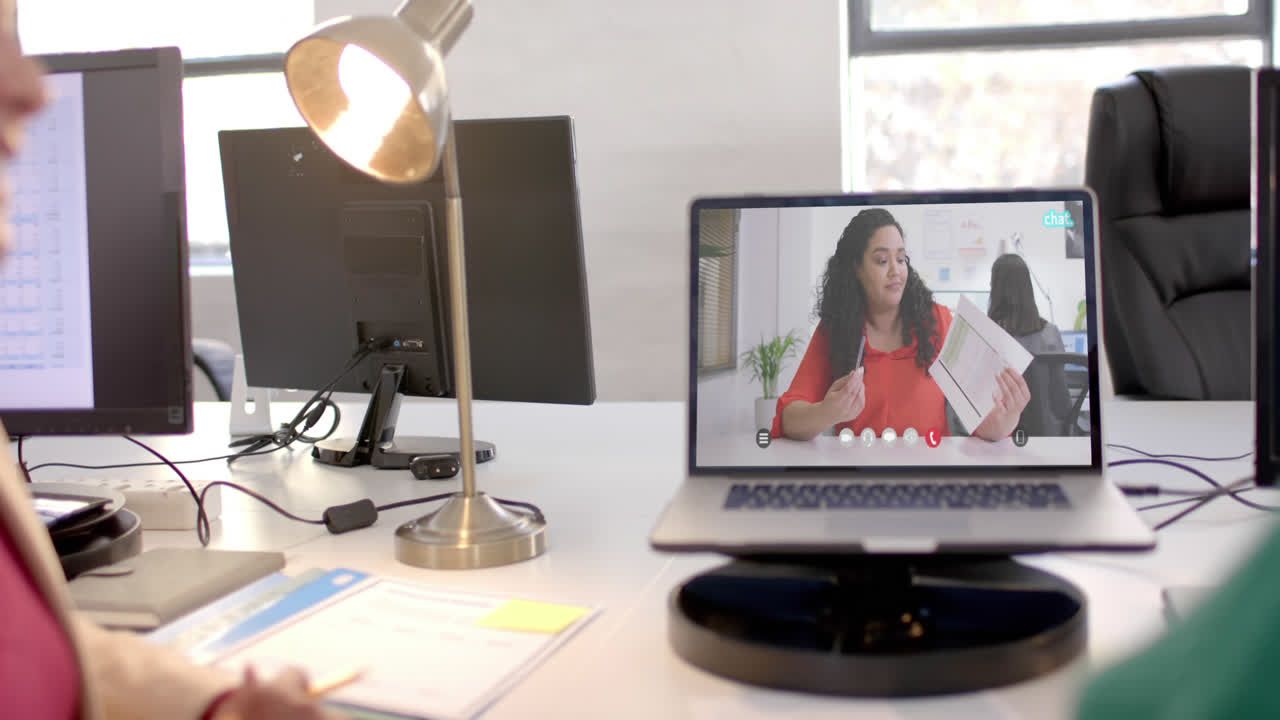 Laptop with video call with caucasian businesswoman on screen