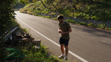 Man Doing Jumping Jacks by the Roadside