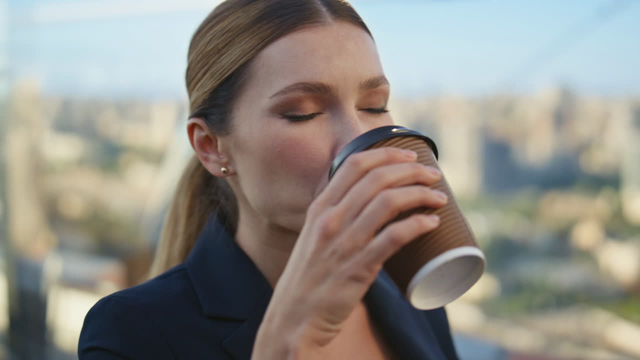 Businesswoman enjoy coffee break tranquility on terrace with city view closeup