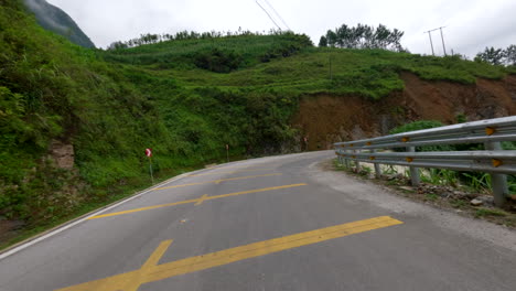 adventure ride of motorbike on curved mountain road at ha giang loop in northern vietnam. pov