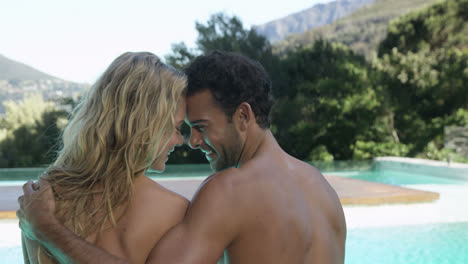 Couple-sitting-with-feet-in-the-pool