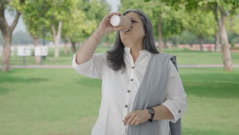 angry indian old woman waiting for someone in park