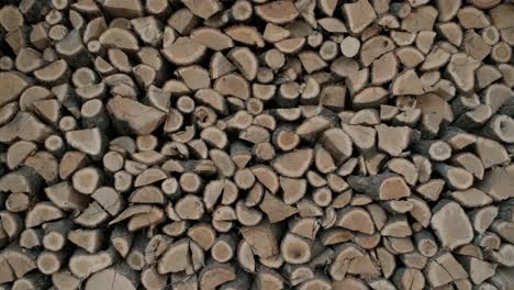 the chopped and sawn trunks of trees is stacked in a large log woodpile. stacks of firewood. pile of firewood prepared for fireplace. firewood background.