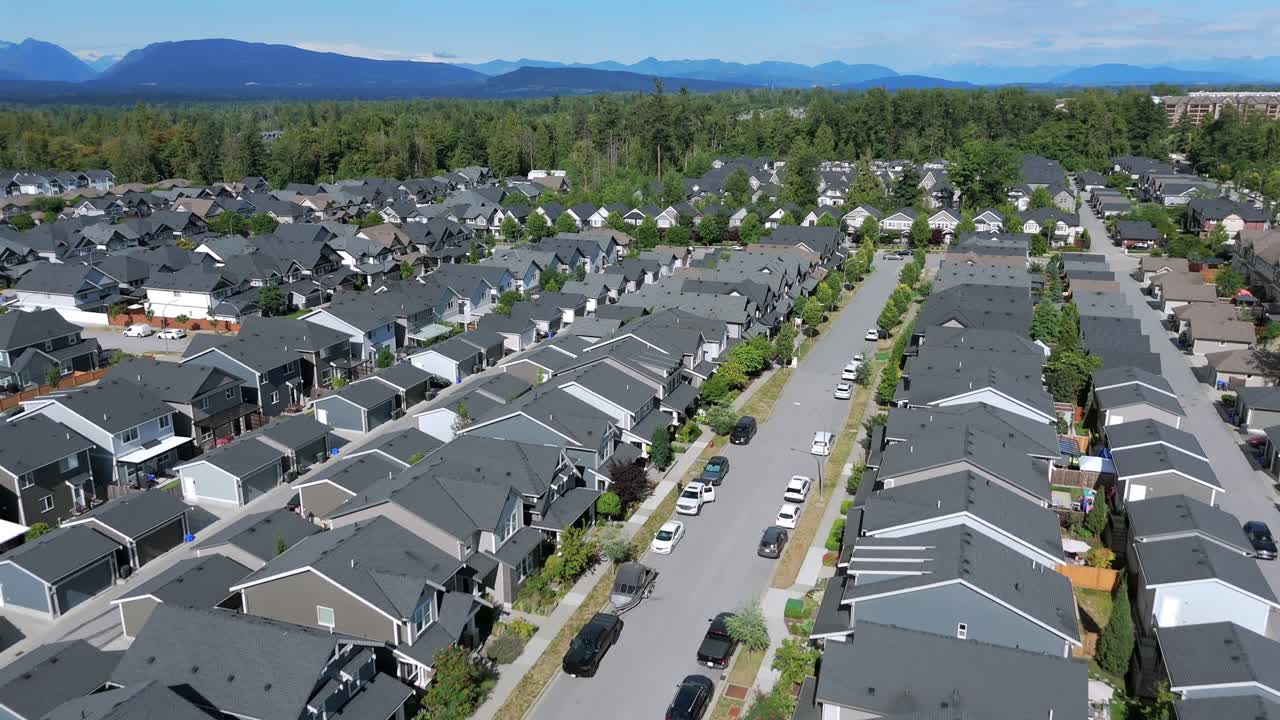 Aerial View Of Modern Suburban Neighborhood With Rows Of Identical Houses In Langley, BC, Canada