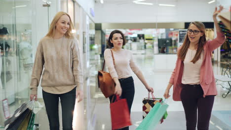 three women shopping in a mall