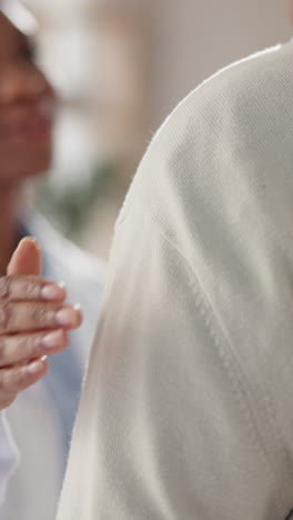 doctor comforting a patient by placing a hand on their shoulder