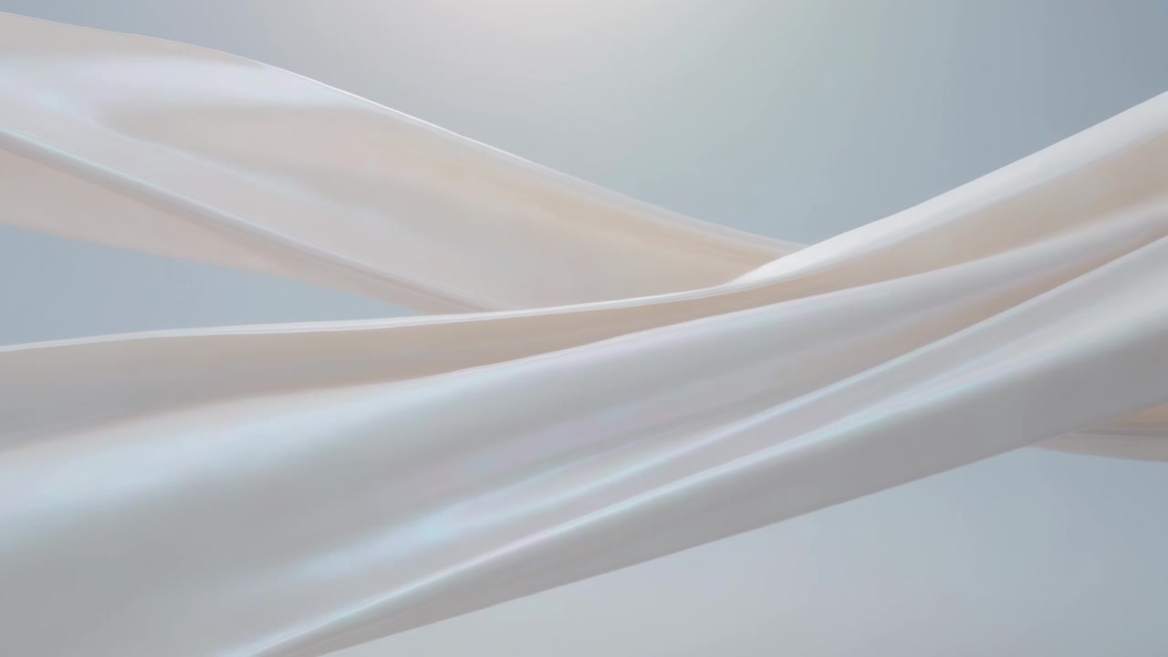 White silk ribbons flowing, crossing as frames roll in cool-gray set under soft light showing sheen
