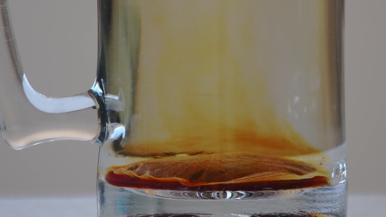 Primo piano stabile degli aromi del tè che si sprigionano nell'acqua calda.