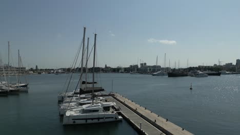 aerial opening view of catamaran marina in valencia, spain, sunny summer day