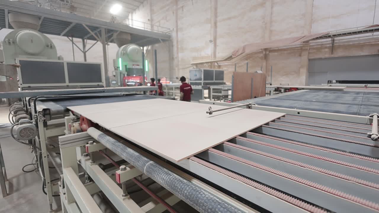 many workers are verifying the pressured ceramic tiles in the conveyor line