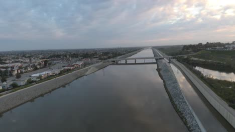 An-amazing-4K-UHD-parallax-aerial-view-gliding-over-the-water-in-an-urban-area-at-sunrise