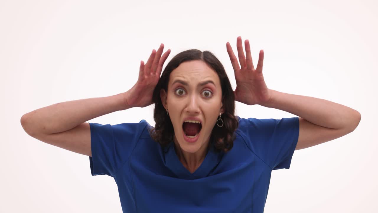 Woman's Emotional Reaction: From Calm to Shock and Fear in Blue Scrubs