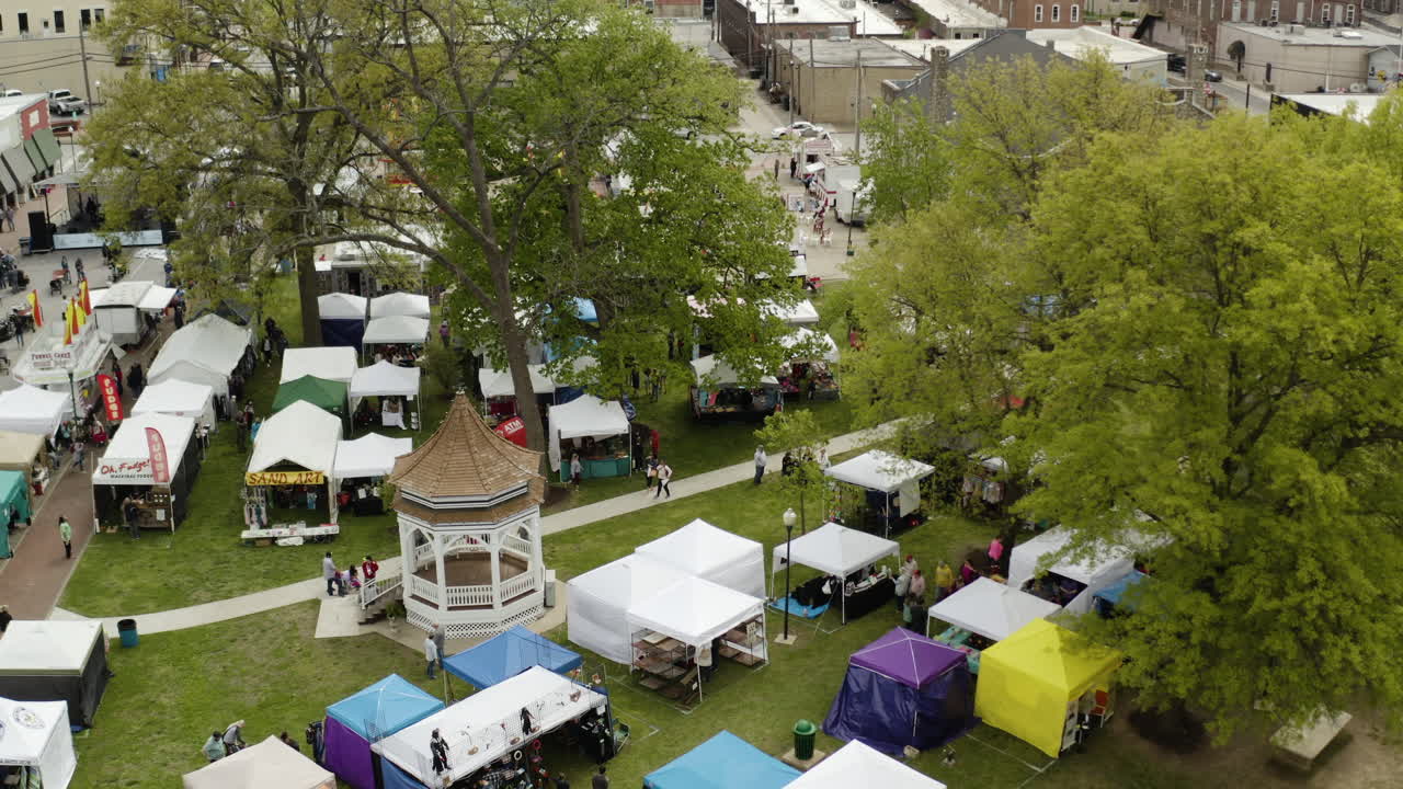 Premium stock video Aerial dogwood festival booths, siloam springs