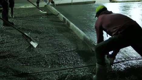 reinforced concrete. worker concretes foundation, rebar, pour cement mortar on reinforcing mesh. builders are building a factory, hangar.