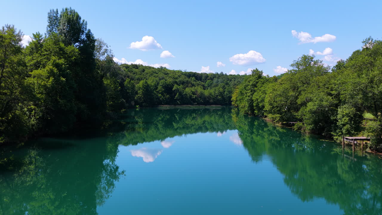 A View Of Mreznica River, Crystal Clear Waters With Reflections In Croatia. Aerial Tilt-up Shot