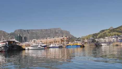 yachts and boats in cape town harbour, view from water on a clear day
