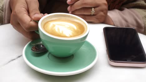 woman drinking coffee in a cafe