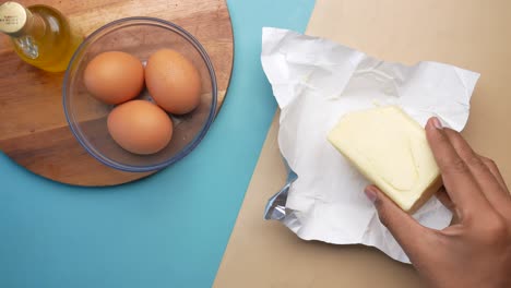 slice of a butter on a paper on table