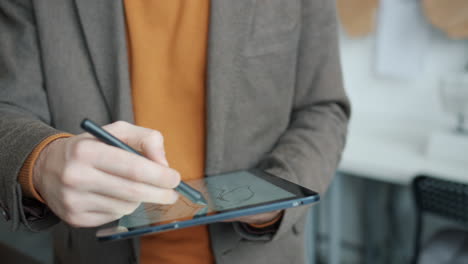 man sketching on a tablet