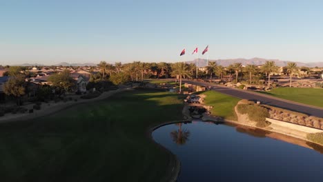drone footage from a golf course near a residential neighborhood in arizona. shot of the water hazard near the course.