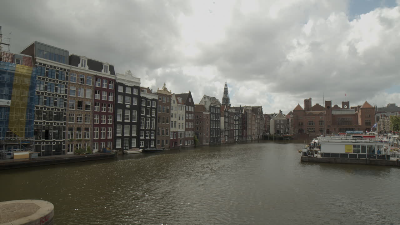 Panning over canal in Amsterdam with houses and docks on water