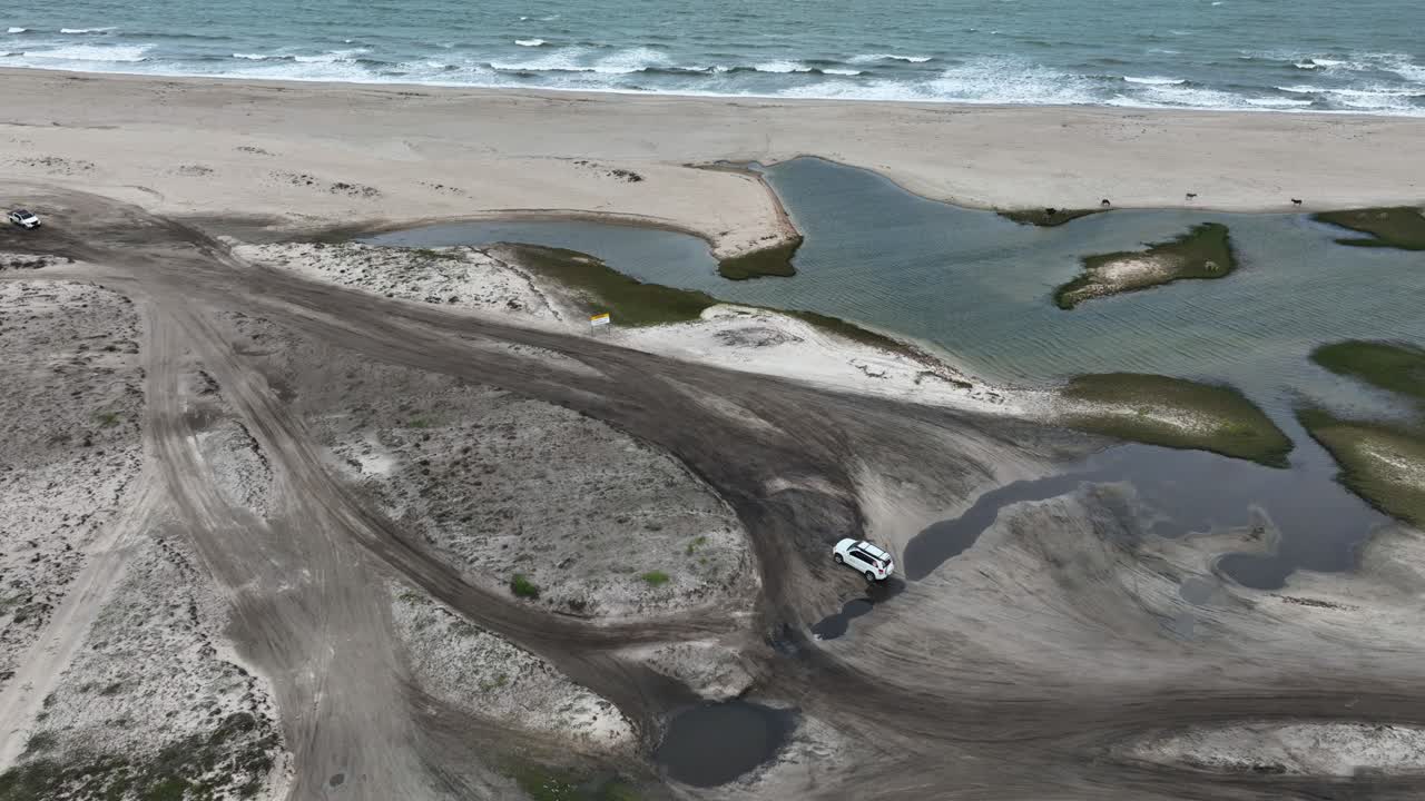 Above View Of 4x4 Vehicles Exploring The Sand Dunes In Jericoacoara, Brazil. Aerial Drone Shot