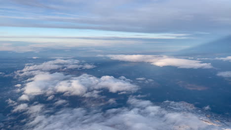 aerial shot from plane over mountains and clouds in norway