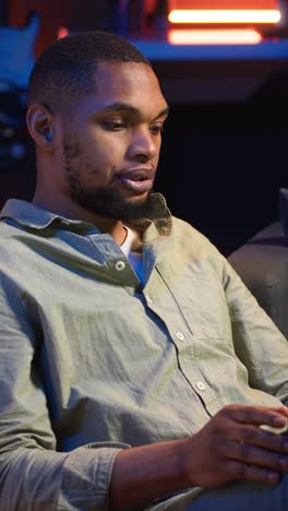 vertical video black man joining online lesson to work on new skills from home space