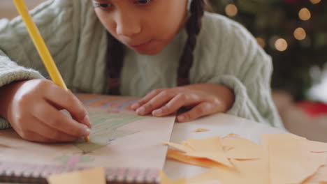 african american girl drawing christmas tree