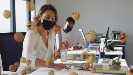 women wearing masks working at desks with floating emoji animation
