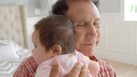 grandfather holding baby granddaughter in slow motion