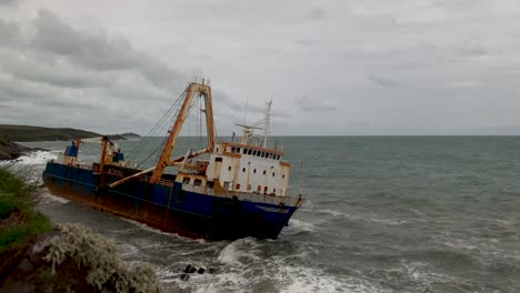 motion time lapse of an abandoned ghost ship stranded on a rocky coast