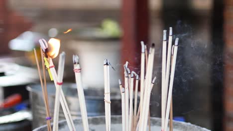 incense sticks burning with flames and smoke