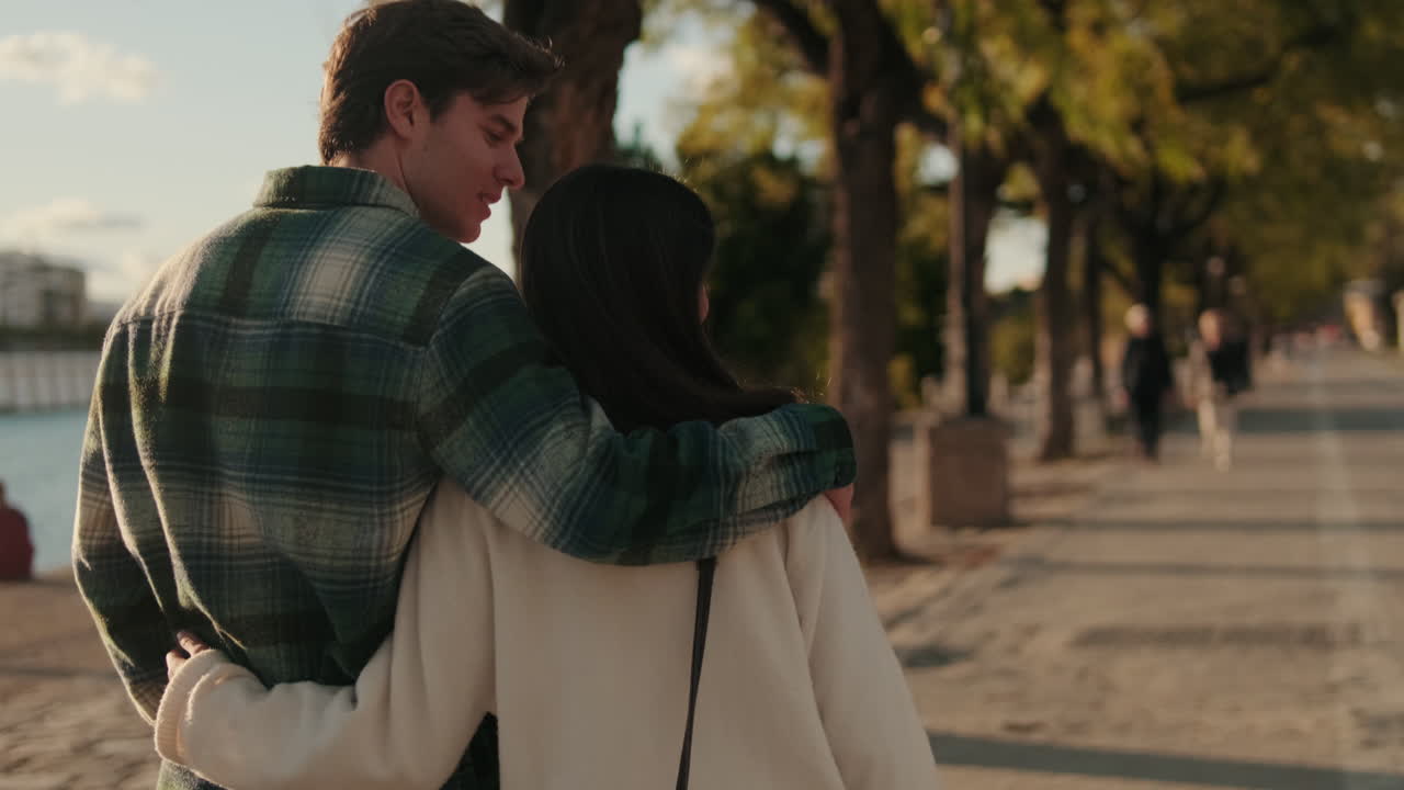 Couple Strolling Along Seville River