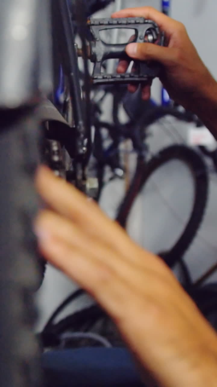 Mechanic repairing bicycle in workshop